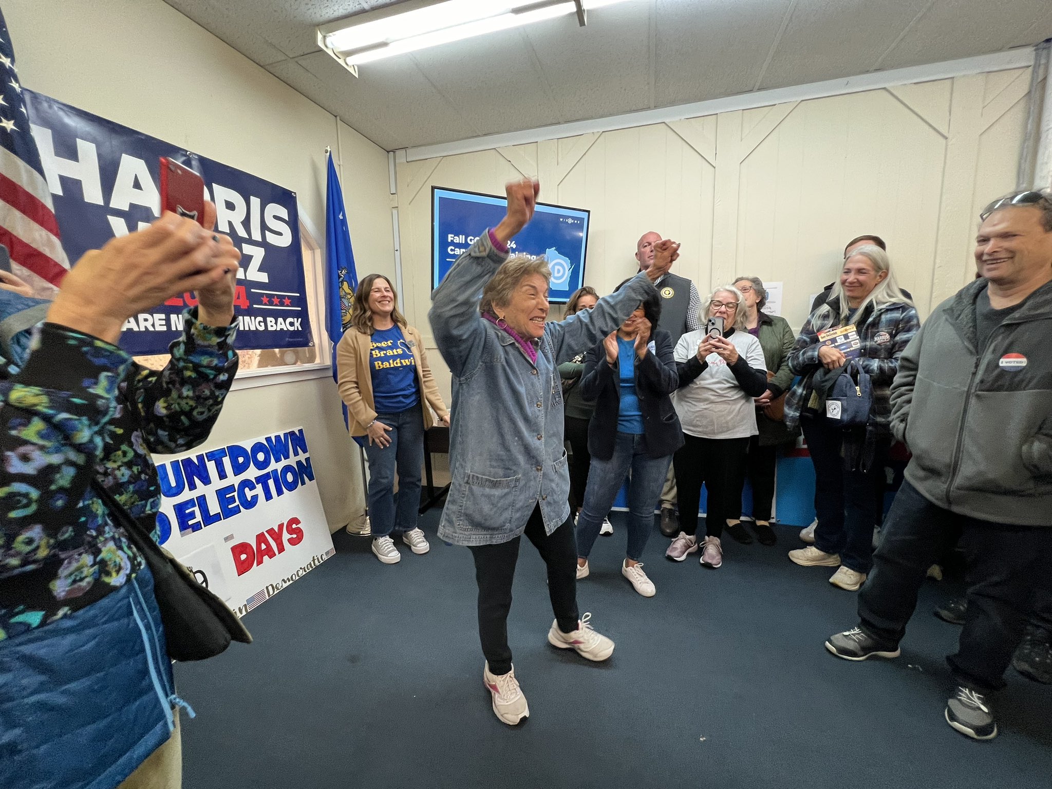 Congresswoman rallying a room of volunteers.